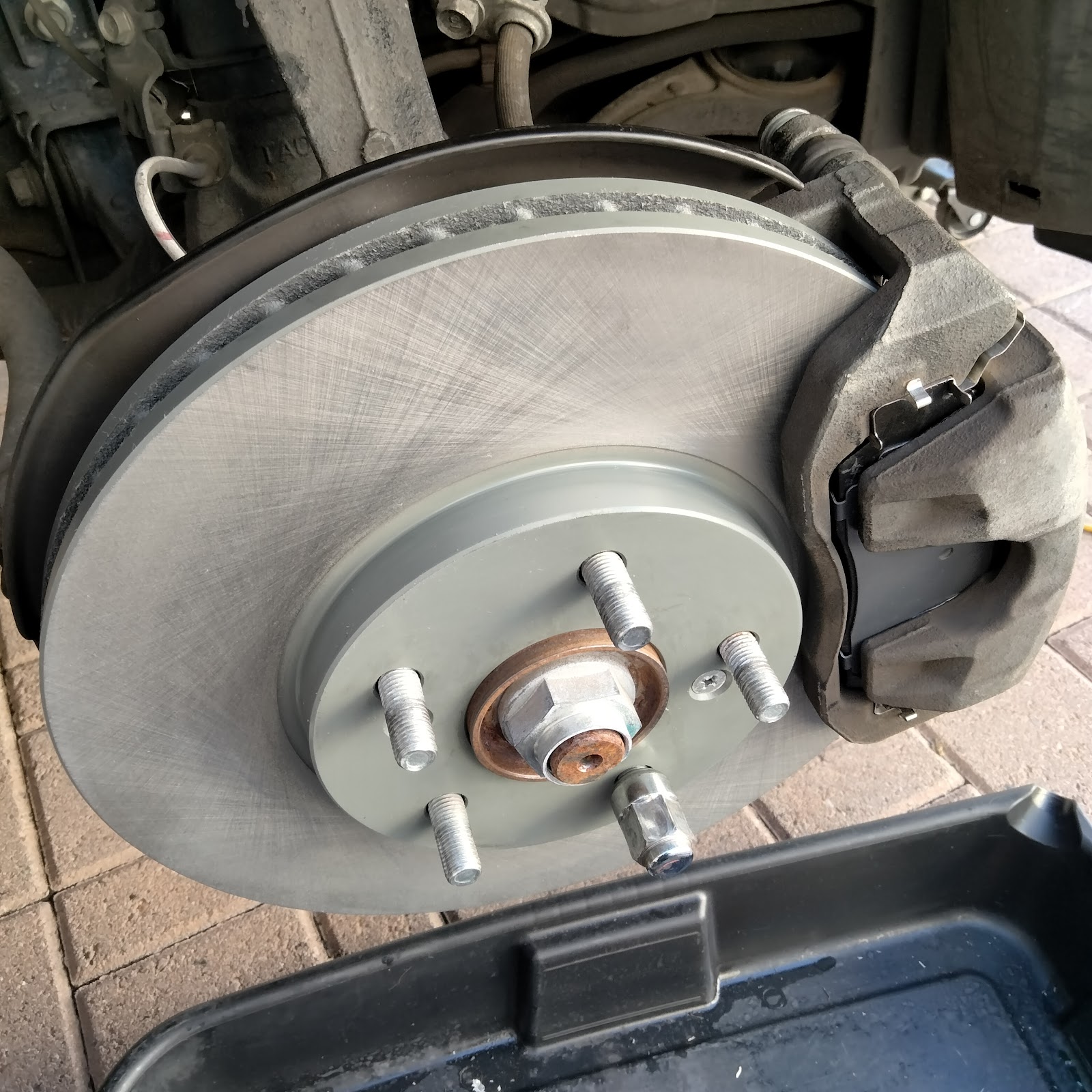 A new brake rotor and caliper assembled on the hub